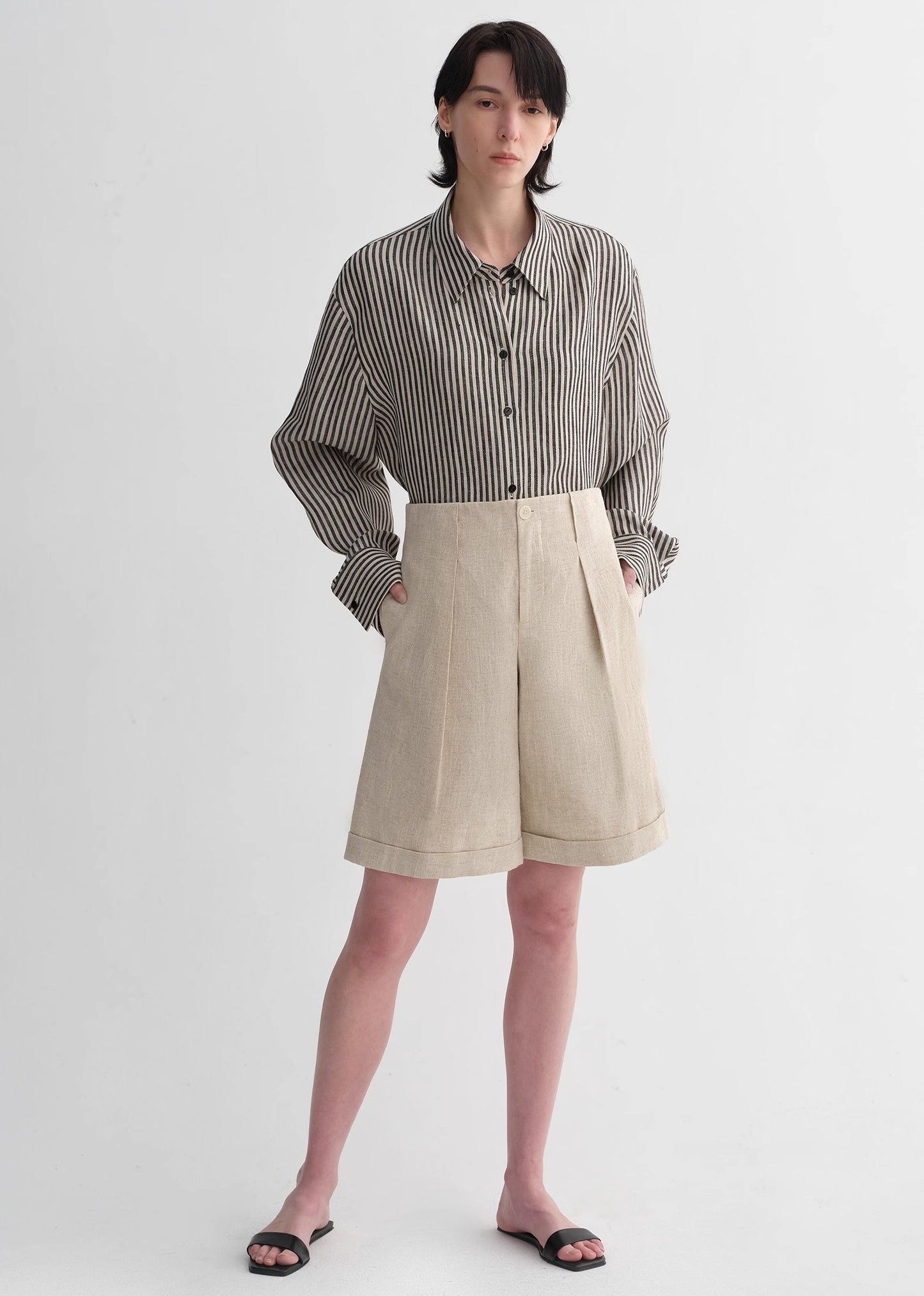 Sophisticated linen waistless pleated wide-leg cropped pants for women, featuring architectural silhouette, textured side pockets