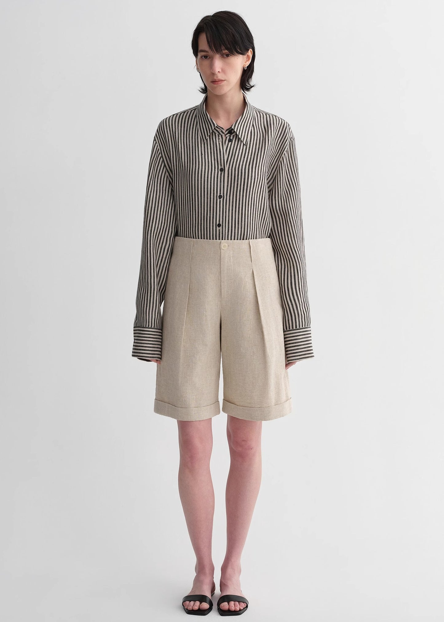 Sophisticated linen waistless pleated wide-leg cropped pants for women, featuring architectural silhouette, textured side pockets