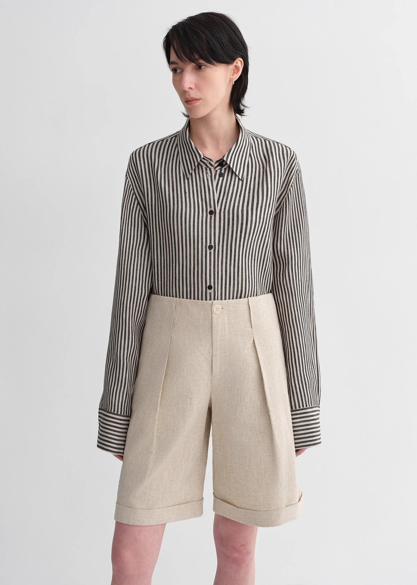 Sophisticated linen waistless pleated wide-leg cropped pants for women, featuring architectural silhouette, textured side pockets