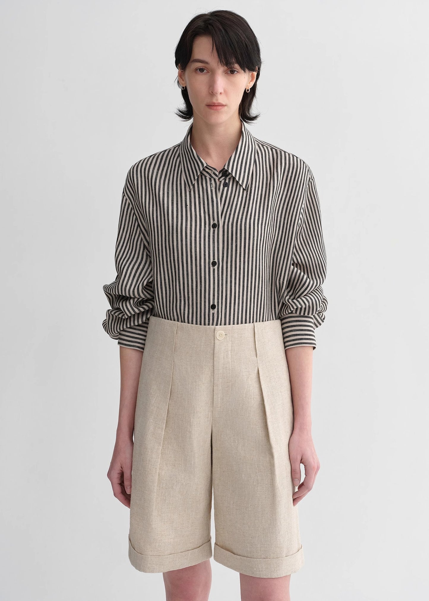 Sophisticated linen waistless pleated wide-leg cropped pants for women, featuring architectural silhouette, textured side pockets