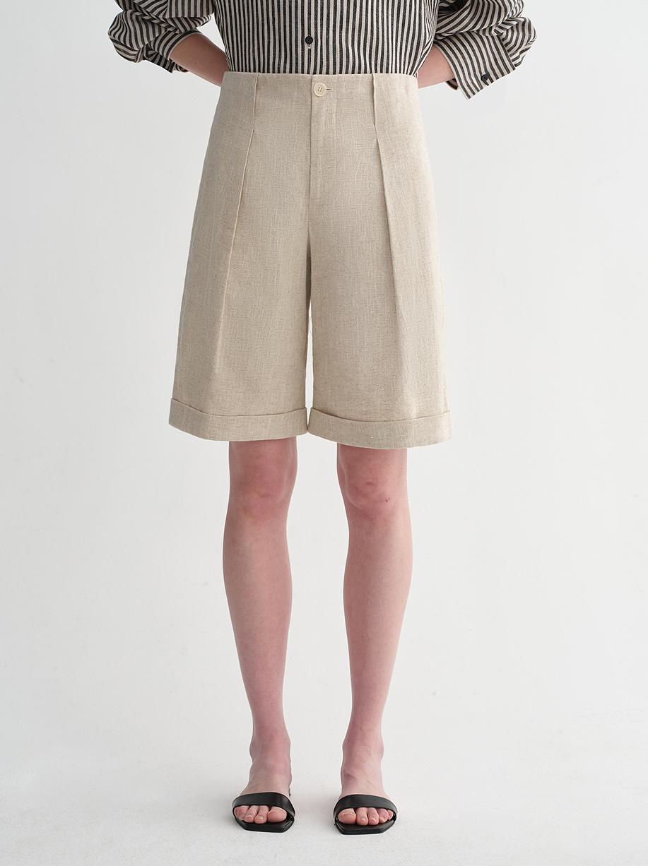 Sophisticated linen waistless pleated wide-leg cropped pants for women, featuring architectural silhouette, textured side pockets
